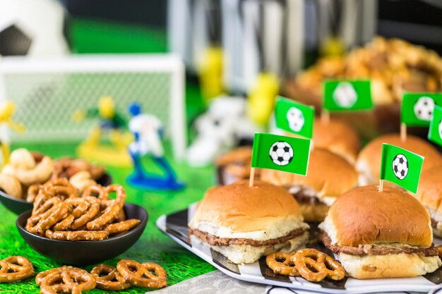 Salty snacks and beer on the table for soccer party.