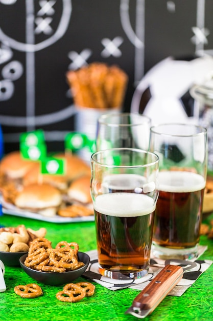 Foto spuntini salati e birra sul tavolo per la festa di calcio.