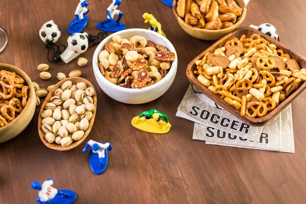 Salty snacks and drinks on the table for soccer party.