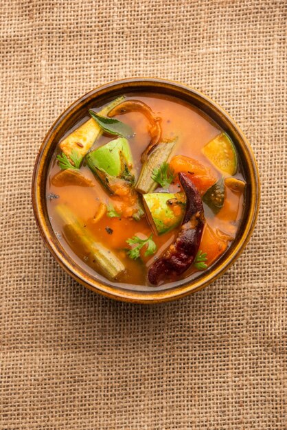 Sambar is a lentil-based vegetable stew/soup, cooked with\
pigeon pea and tamarind broth. it is popular in south indian and\
sri lankan cuisines.