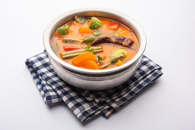 Sambar is a lentil-based vegetable stew/soup, cooked with\
pigeon pea and tamarind broth. it is popular in south indian and\
sri lankan cuisines.