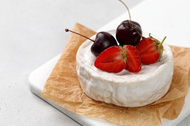 Samembert cheese with cherries and strawberries Cheese and berries