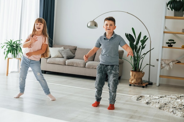 Samen dansen kinderen hebben overdag plezier in de huiskamer