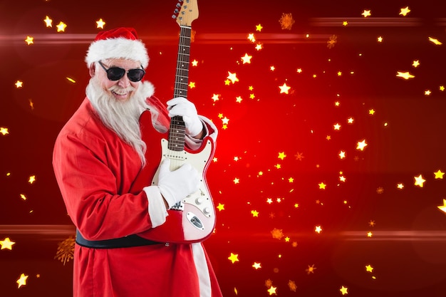 Samengesteld beeld van glimlachende kerstman die gitaar speelt