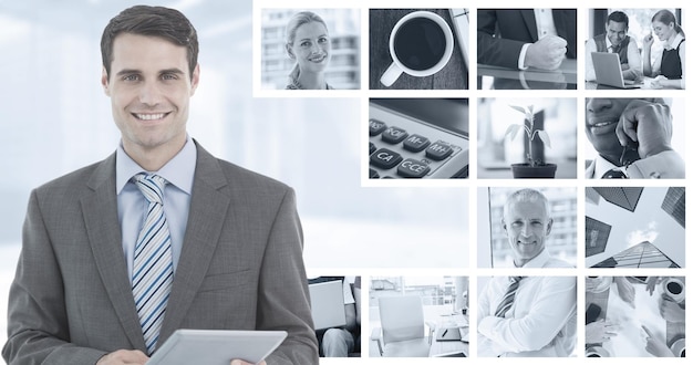 Samengesteld beeld van zakenman die een tablet gebruikt met collega's achter op kantoor