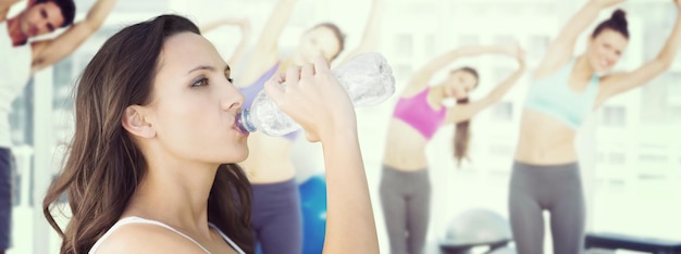 Samengestelde afbeelding van mooie vrouw drinkwater uit fles