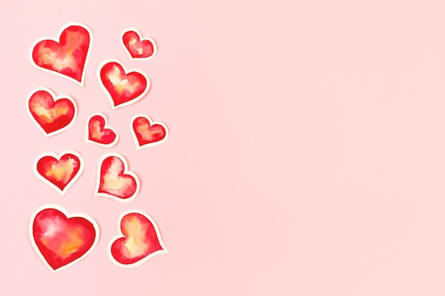 Samenstelling met rode aquarel papier harten. Achtergrond met kopie ruimte voor Valentijnsdag.
