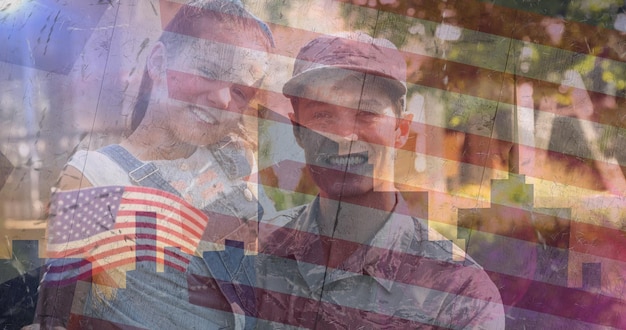 Samenstelling van mannelijke soldaat die glimlachende dochter omhelst over Amerikaanse vlag