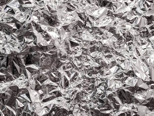 Samenvatting van de achtergrond van de aluminiumfolietextuur voor ontwerp. Metallic foliedocument achtergrond.