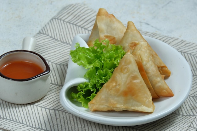 samosa or sambosa crunchy triangular shaped wraps stuffed with meat and spicy vegetables