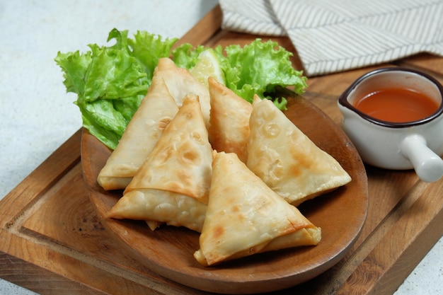 samosa or sambosa crunchy triangular shaped wraps stuffed with meat and spicy vegetables