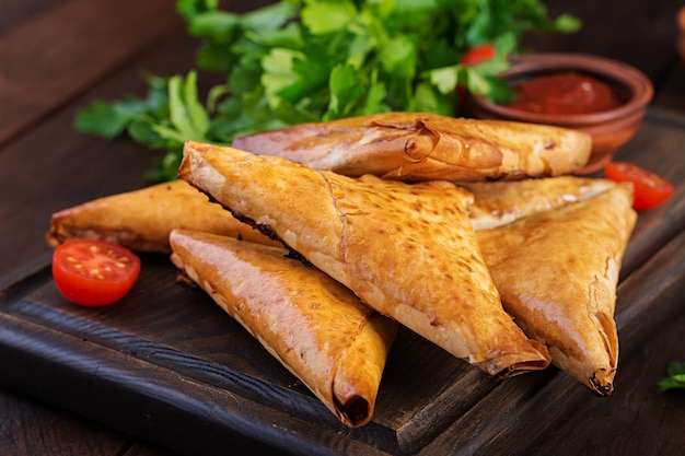 Samosas with chicken fillet and cheese.