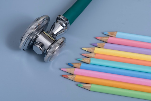 Sample of colored pencils and a stethoscope representing the pediatric doctor