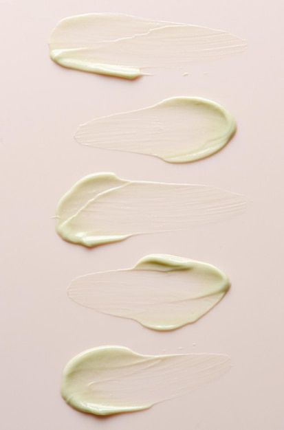 A sample of moisturizer on a pink background Cosmetic product for the skin