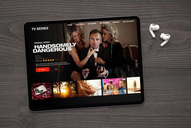 Sample TV series and movies streaming app on digital tablet and wireless earbuds on the table