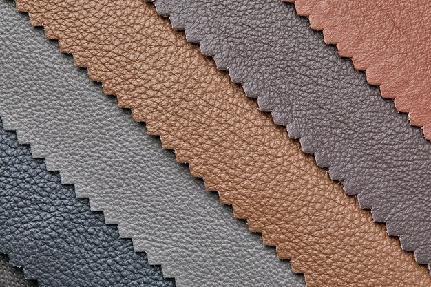 Samples of beige brown gray black leather leather crafts and\
craftwork view from above