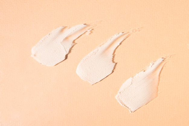 Samples of clay for treatment and cleansing of the skin on a beige background