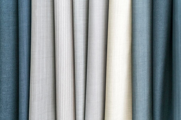 Photo samples of fabric - trouser fabrics of different colors on the display case