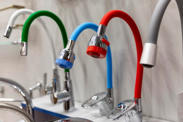 Samples of faucets for bathroom and kitchen in the store A variety of modern models Construction and repair Selective focus