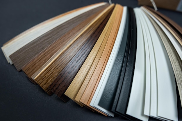 Photo samples of laminate and vinyl tiles on wooden background isolated