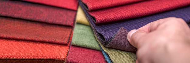 Samples of textiles for upholstery in different colors and thicknesses closeup details of multicolor...