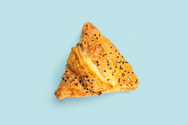 Samsa with meat on blue background top view