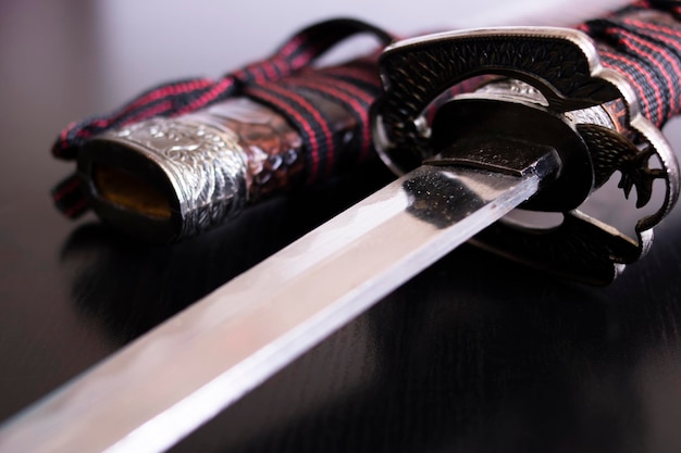 Samurai sword and scabbard on wooden background