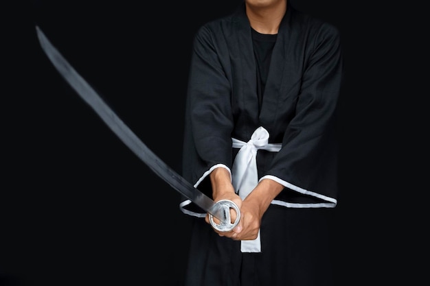 A Samurai warrior holding a sword with a black background