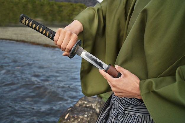 Samurai with sword outdoors