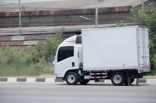 Samut Sakhon, Thailand - April 2019: A small white truck running on Rama 2 Road on April 6, 2019 in Samut Sakhon, Thailand.