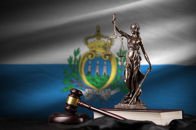 San Marino flag with statue of lady justice constitution and judge hammer on black drapery Concept of judgement and guilt