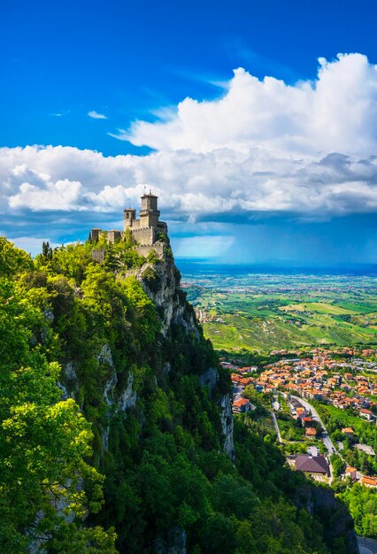 San Marino medieval tower on a rocky cliff and panoramic view of Romagna