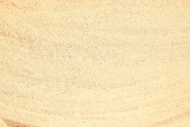Photo sand by the sea texture background.