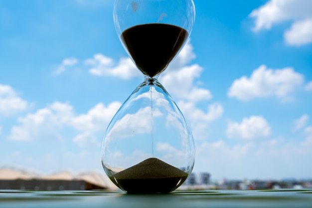 Sand clock with sky and cloud business concept