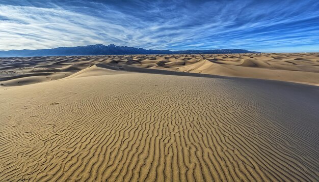 a sand dune with a mountain in the background