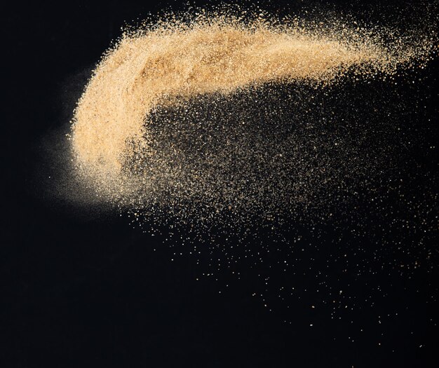 Sand flying explosion Golden sand wave explode Abstract sands cloud fly Yellow colored sand