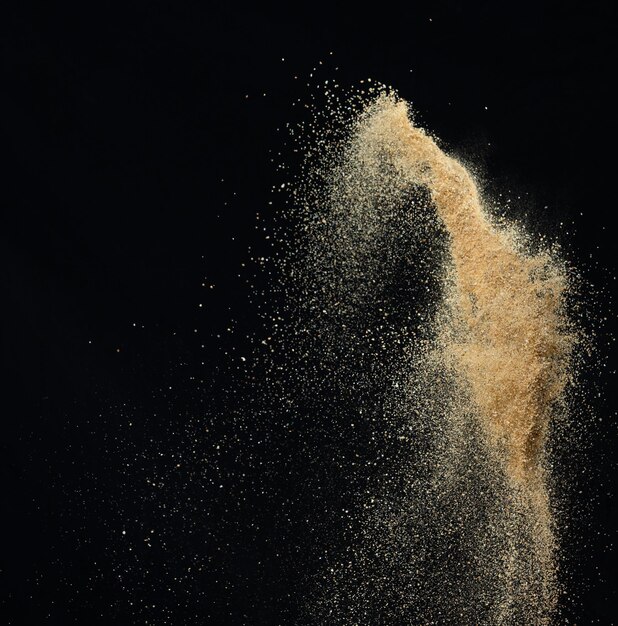 Sand flying explosion Golden sand wave explode Abstract sands cloud fly Yellow colored sand