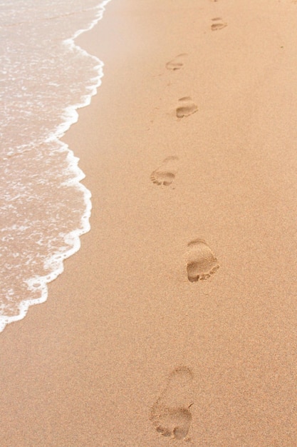 Photo sand footsteps trace summer vacation beach