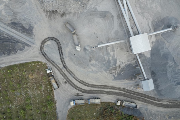 Sand loaders are shoveling rocks into dump trucks