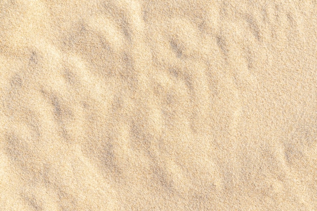 Photo sand pattern texture for background. brown desert pattern from tropical beach. close-up.