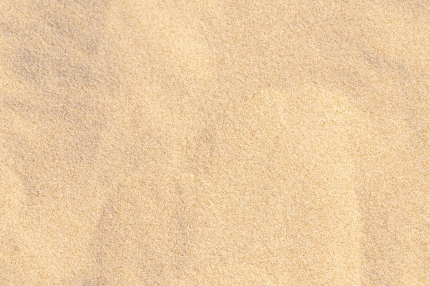 Photo sand pattern texture for background. brown desert pattern from tropical beach. close-up.