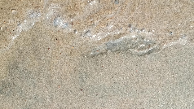 Sand of the river bank a blurry image of a sand pattern a human footprint in the sand closeup