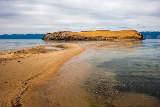 Sand spit leads to rocky island on Lake Baikal