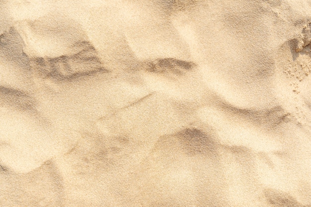 Предпосылка текстуры песка на пляже. Светло-бежевый узор текстуры морского песка, предпосылка песчаного пляжа.