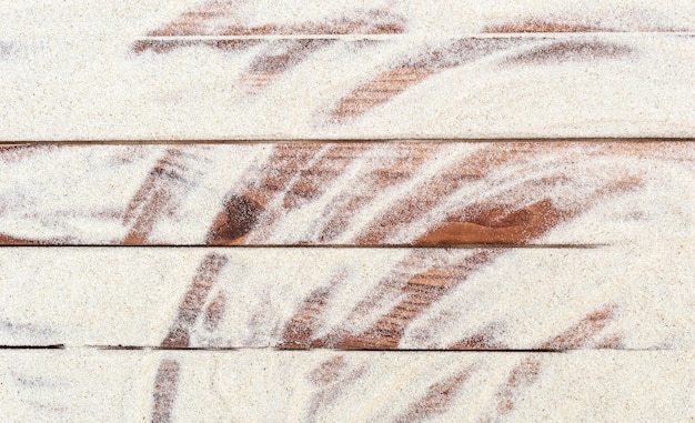 木製の板の上の砂の抽象的な背景