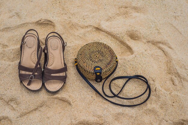 Sandals and Balinese wicker bag on the sand