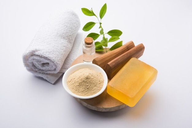 Sandalwood or Chandan Handmade Bath Soap. Placed with Oil, Ubtan, Sticks and Towel, selective focus