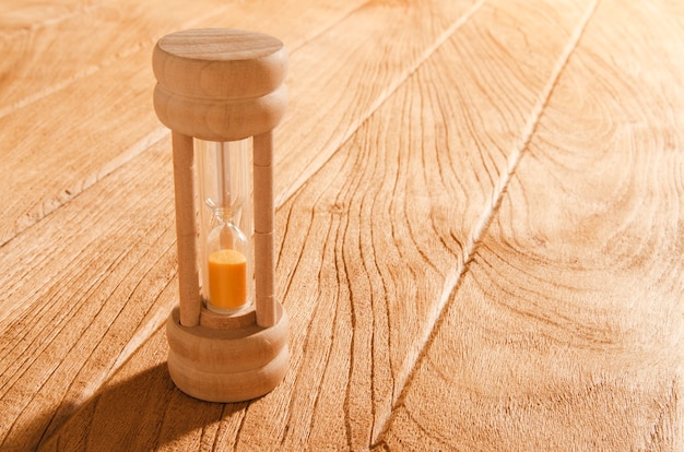 Photo sandglass on the wooden table