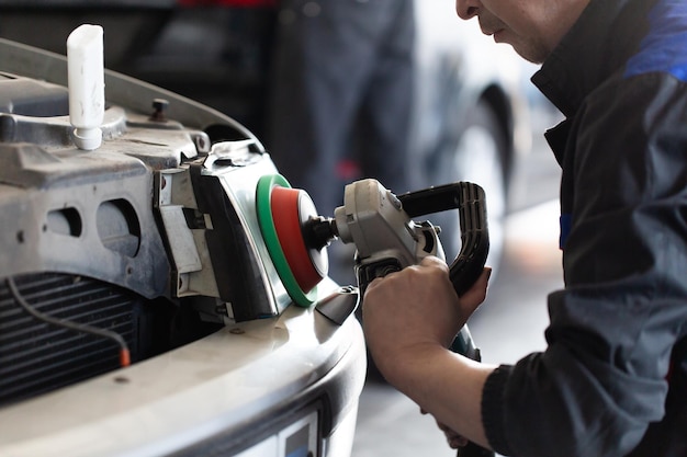 Sanding polishing headlights on a car on a hundred closeup