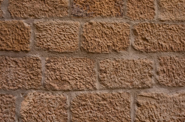 Sandstone brick wall background. Texture.